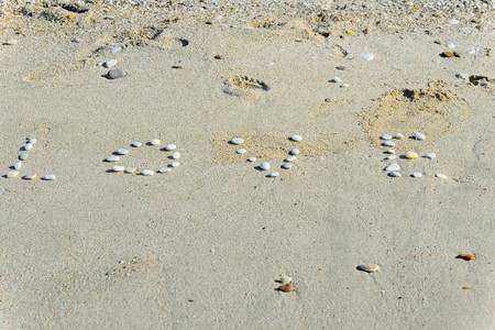 The word love written at the beachの写真素材