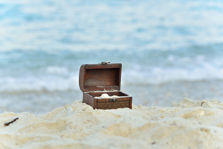 Treasure chests in the sand on the seashoreの写真素材