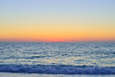 Sunrise over the sea at Marble Beach in Greeceの写真素材
