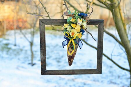 3d picture in nature. Dried flowers in a very old photo frame, hanging in a treeの写真素材