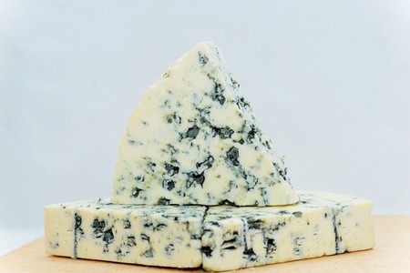 Blue cheese is a general classification of cheeses that have had cultures of the mold Penicillium added so that the final product is spotted or veined throughout with blueの写真素材