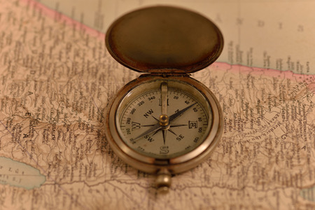 Old compass on the background of old mapsの写真素材