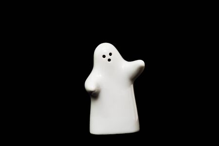 White porcelain figurine on black backgroundの写真素材