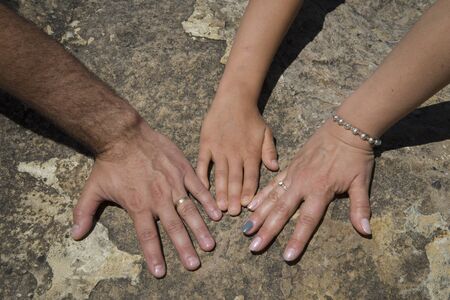 The hands of a family, father, mother and boyの写真素材