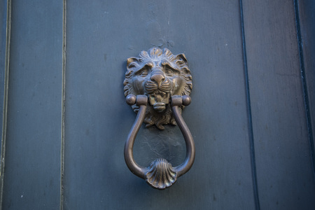 Decorative metal ring knock door, in Italy most homes have doors with these handles.
