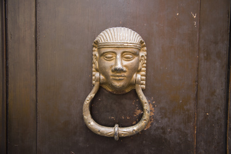 Decorative metal ring knock door, in Italy most homes have doors with these handles.の写真素材