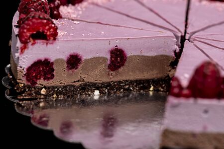 Raw vegan cake with chocolate and raspberries, a healthy and tasty dessert, sugar-free, gluten-freeの写真素材
