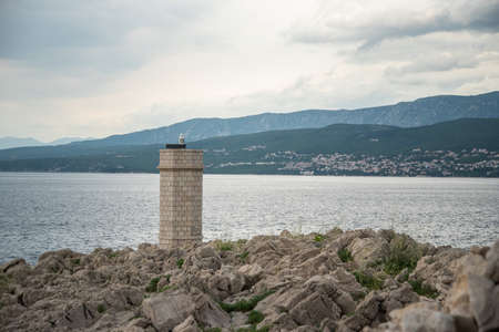 Silo lighthouse in Punta Silo (Å¡ilo), Kvarner bay on Krk island, Croatia and the view of Crikvenicaの写真素材