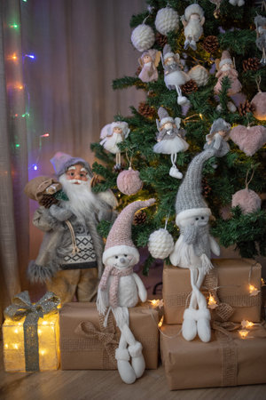 Christmas decorations under the Christmas tree, Gifts, lights and fluffy globesの写真素材