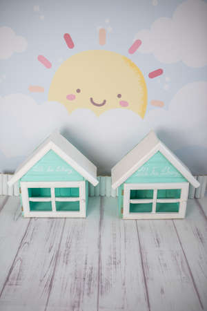 Decor for photo sessions consisting of cheerful houses, clear sky, sun, fence and wooden floorの写真素材