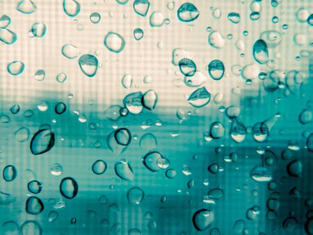Abstract raindrops on a double glazed windowの写真素材