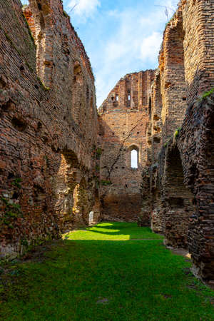Ruined walls of a medieval citadel fortress. Cracked brick walls and decaded window arches can be seen in the photo. Citadel walls in ruin with arches and collumns.の写真素材