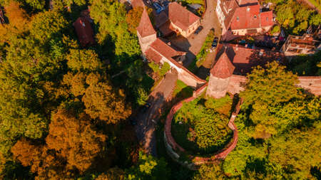 Aerial photography of a fortified gate with towers at medieval town of Sighisoara located in Romania. Aerial photography above a mdieval city with fortified walls and towers.の写真素材