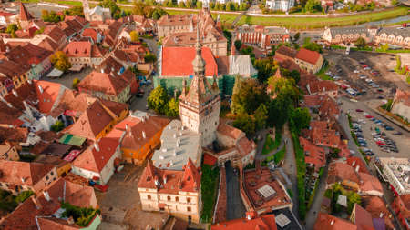Aerial photography of medieval city of Sighisoara from Romania, taken from a drone with the Clock Tower in the front. Birds eye view over Sighisoara city.の写真素材