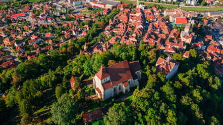 Landscape photography of Sighisoara medieval town, located in Romania. Photo was taken from a drone as a panorama over the old city. Drone shot of the old town of Sighisoara, taken from above.の写真素材