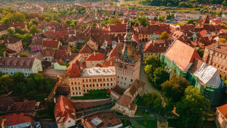 Aerial photography of medieval city of Sighisoara from Romania, taken from a drone with the Clock Tower in the front. Birds eye view over Sighisoara city.の写真素材