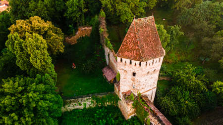 Aerial photography of a medieval tower fortification called Turnul Cositorarilor, located in medieval town of Sighisoara, Romania. Aerial view of a medieval defensive tower.の写真素材