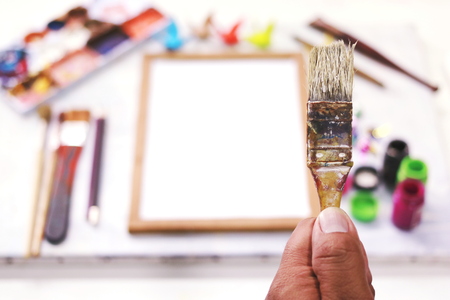 Top view. Hand man holding paintbrush on tool background.の写真素材