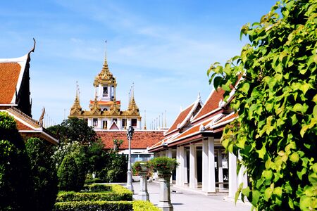 Roof temple and guide post Thai Language on blue sky.Temple name Wat Ratchanadda in Bangkok. Thailand.の写真素材