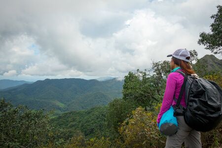Women see in mountain. Woman travel see in forest and cloud  sky background. A Woman  travel on...