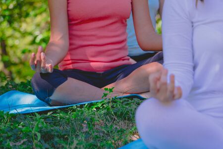 Body part group people have meditation for yoga.They are play yoga in park.good air,hobby, Zen, Photo concept freedom and good health.の写真素材