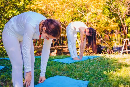 Group people have meditation for yoga.In the morning they are sitting on mat and play yoga in...