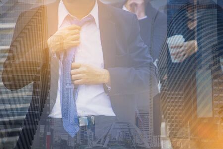 Double exposure picture. Picture mix  building city and businessman is necktie show Confident. Picture concept action man and business .の写真素材