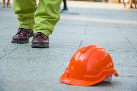 A man walking in to orange hat. Engineer man walking for work.He move left foot.It is symbol for good work.Photo engineer and work.の写真素材