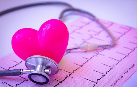  Green stethoscope and pink Heart.They are check heart wave on white background. Photo concept healthcare good feel.の写真素材