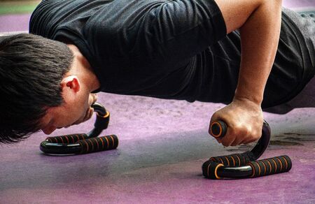 planking.Young man planking. A man Asian push up or planking.He is wearing sportswear for...