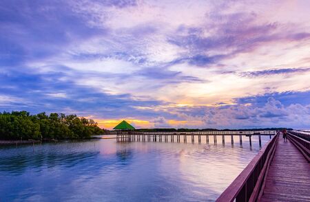 In the morning The red bridge and sun up or sun set  on horizon.  bridge cross sea in to the forest Thailand .Photo concept for Thailand landscape .の写真素材