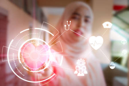 Young student Islamic woman. She is sitting and reading book.She is smile and relax time, woman Portrait, Photo concept portrait and life style.の写真素材
