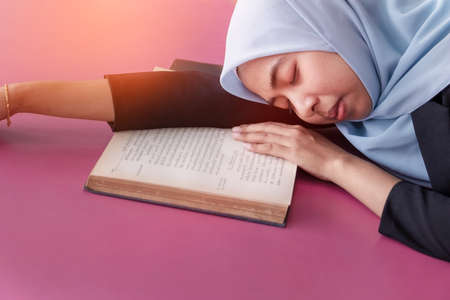 Young student Islamic woman. She is sitting and reading book.She is smile and relax time, woman Portrait, Photo concept portrait and life style.の写真素材