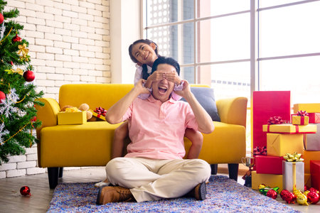 Young Asia dad and daughter in living room at house.They are happy and cheerful.Happy family,together. Photo enjoy and  happy family concept idea.の写真素材