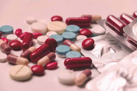 Close up medicine and capsules on white background.colorful drug for treatment medication.Capsules , packages,capsule pills.Photo concept take care and background.の写真素材
