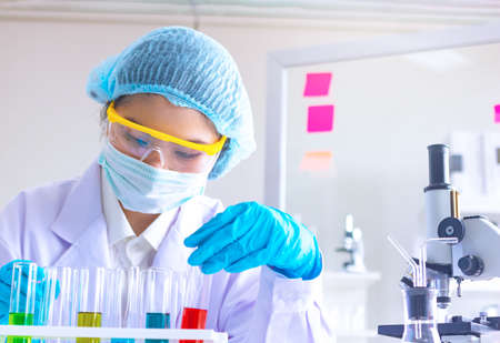 Body past scientist working in laboratory.She is trying and research with red and blue test tube. Experiment , chemical Photo concept develop and medicine.の写真素材