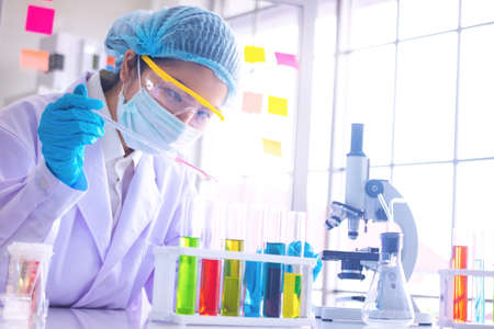Body past scientist working in laboratory.She is trying and research with red and blue test tube. Experiment , chemical Photo concept develop and medicine.の写真素材