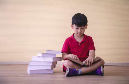 Portrait Asian cute  boy. He is sitting with Dumbbell.He is action in room.Child boy raise dumbbell.lovely,nice,cute,

photo concept freedom  and  Kid portrait.の写真素材