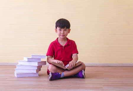 Portrait Asian cute  boy. He is sitting with Dumbbell.He is action in room.Child boy raise dumbbell.lovely,nice,cute,

photo concept freedom  and  Kid portrait.の写真素材