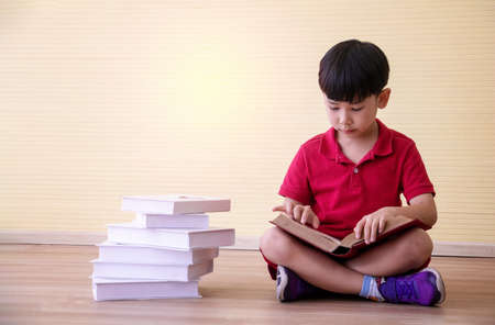 Portrait Asian cute  boy. He is sitting with Dumbbell.He is action in room.Child boy raise dumbbell.lovely,nice,cute,

photo concept freedom  and  Kid portrait.の写真素材