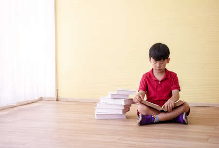 Portrait Asian cute  boy. He is sitting with Dumbbell.He is action in room.Child boy raise dumbbell.lovely,nice,cute,

photo concept freedom  and  Kid portrait.の写真素材