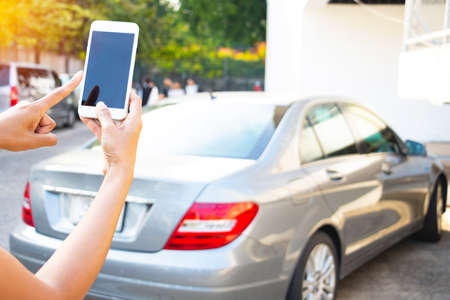 Close up hand man using remote for open car.transport, business trip,Photo concept Lifestyle and technology.の写真素材