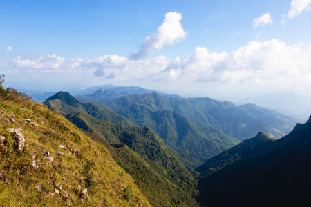 Blue sky and Yellow field with white clouds.landscape picture In Thailand.The Mountain nameâDoi Luangâ in Tak Province Thailand.の写真素材