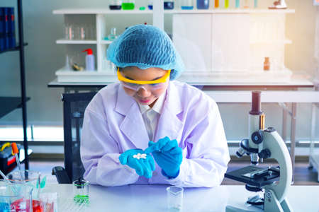 Body past scientist working in laboratory.Chemical scientist show white medicine.She Experiment,pill,study.Photo concept develop and medicine.の写真素材