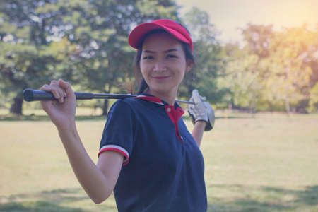 Portrait Asia woman play golf.She is playing golf on a sunny day.の写真素材
