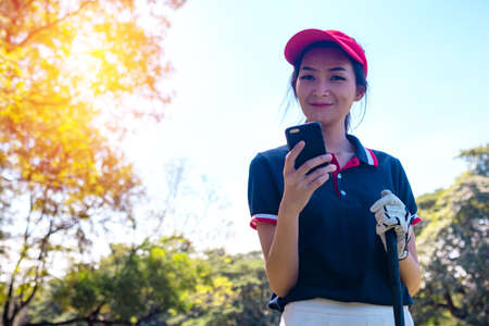 Portrait Asia woman play golf.She is playing golf on a sunny day.の写真素材