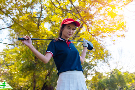 Portrait Asia woman play golf.She is playing golf on a sunny day.の写真素材