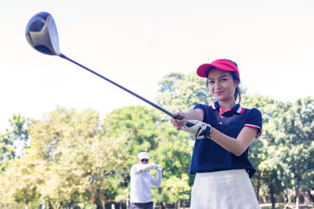Portrait Asia woman play golf.She is playing golf on a sunny day.の写真素材