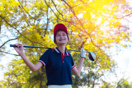 Portrait Asia woman play golf.She is playing golf on a sunny day.の写真素材