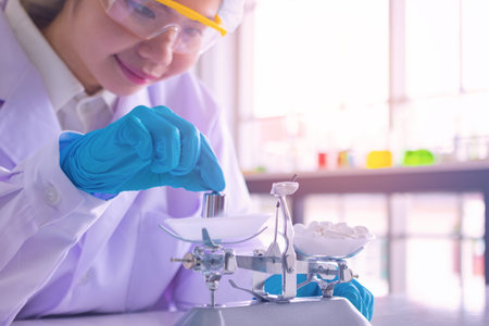 Body past scientist working in laboratory. She is looking in test tube. She is trying and research with blue test tube. Experiment, chemical. Photo concept develop and medicine.の写真素材